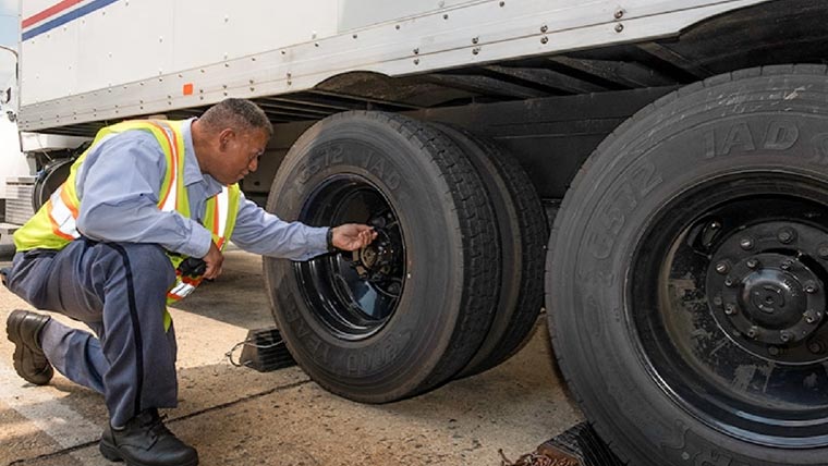 USPS Tractor Trailer Operators meeting outside before they start their routes.